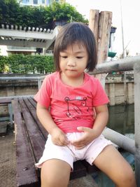 Cute girl sitting outdoors