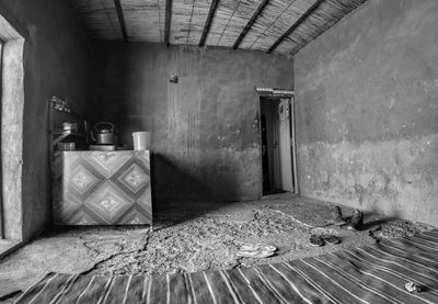 Inside a rest stop in the desert of sudan with a blue carpet and a stove 