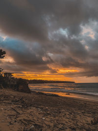 Scenic view of beach against sky during sunset