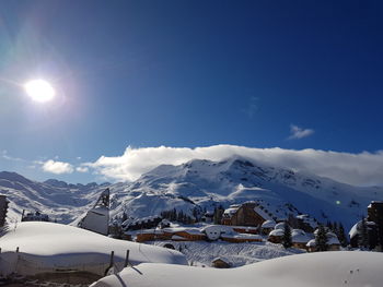 Scenic view of snowcapped mountains against blue sky