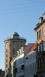 Low angle view of buildings against blue sky