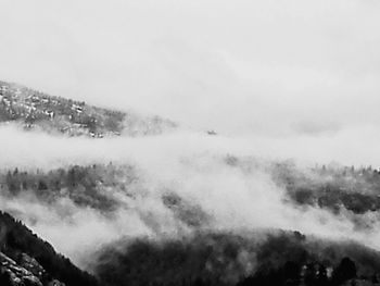 Scenic view of mountain range against cloudy sky