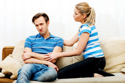 Couple discussing on sofa at home