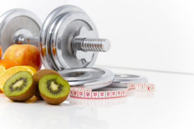 Close-up of fruits on table against white background