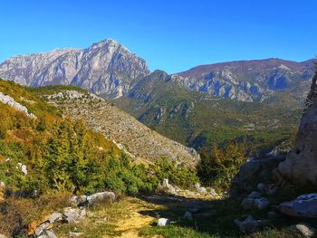 Scenic view of mountains against clear blue sky