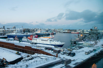 High angle view of boats moored at harbor during winter