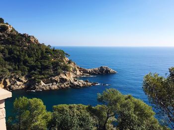 Scenic view of sea against clear blue sky