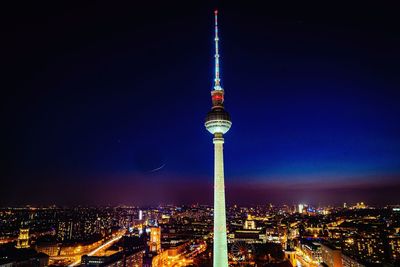 Aerial view of illuminated buildings in city at night