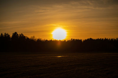 Scenic view of field against sky during sunset