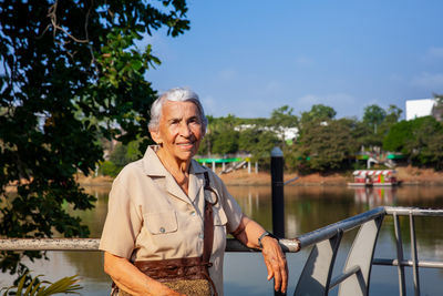 Senior woman at the ronda del sinu walking path along the river bank in montería, colombia.