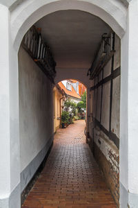 Empty alley amidst buildings in city