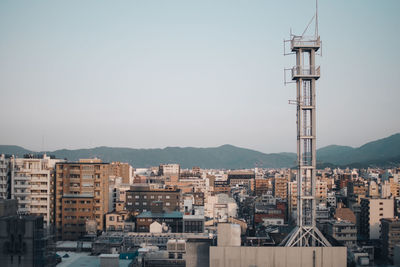 Buildings in city against clear sky