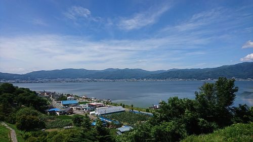 High angle view of sea and buildings against sky