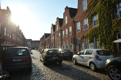 Cars on street amidst buildings in city