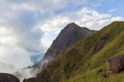 Scenic view of mountains against cloudy sky