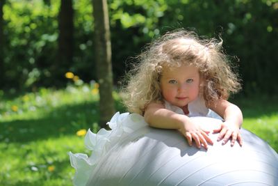 Portrait of cute girl standing on field