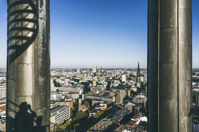 Aerial view of buildings against clear sky