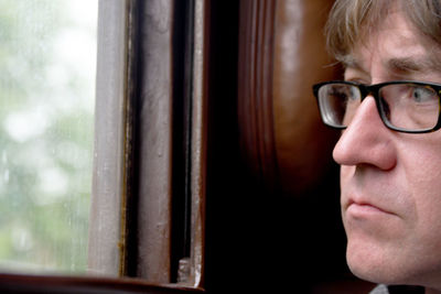 Close-up portrait of man wearing eyeglasses