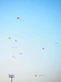 Low angle view of kite flying against blue sky