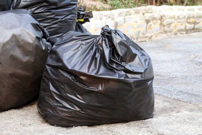 Close-up of man sitting on garbage