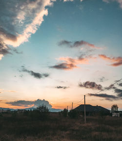 Scenic view of silhouette field against sky during sunset