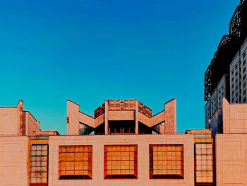 Low angle view of building against clear blue sky