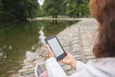Midsection of woman using mobile phone