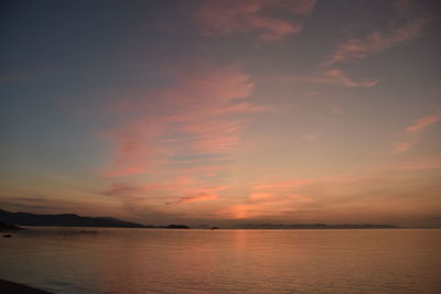 Scenic view of sea against romantic sky at sunset