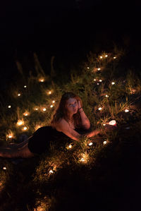 Young woman in illuminated at night