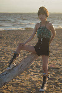 Full length of young woman on beach