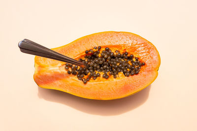 Close-up of orange fruit against white background