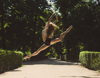 Amazing ballerina pose outdoors dancing, lifestyle concept.