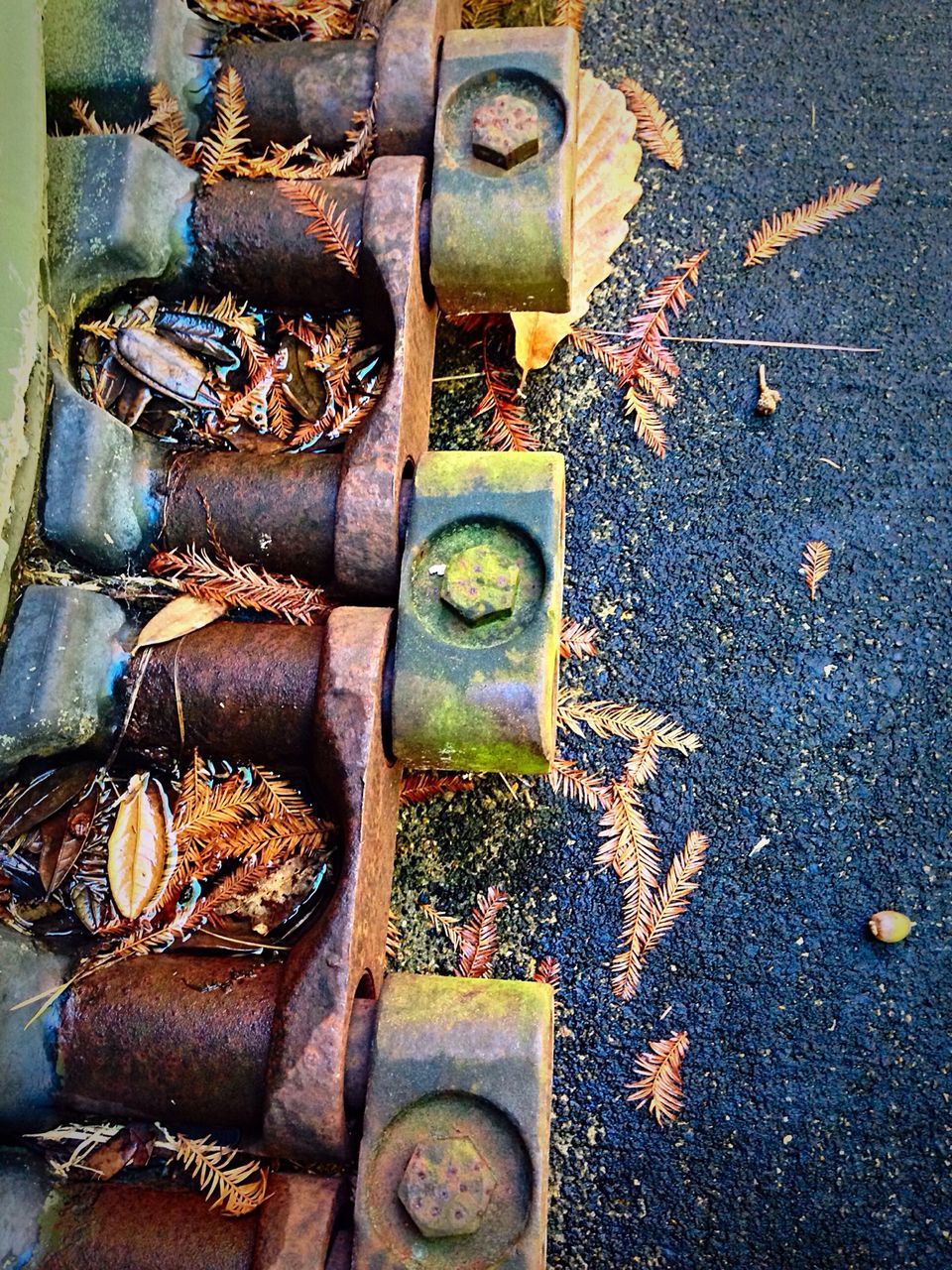 metal, high angle view, still life, close-up, old, metallic, shoe, large group of objects, no people, abundance, variation, outdoors, abandoned, day, stack, rusty, in a row, stone - object, sunlight, arrangement