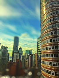Modern buildings against cloudy sky