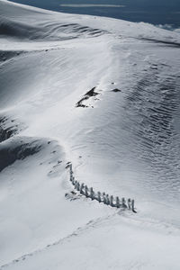 High angle view of footprints on snow covered land