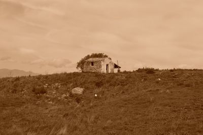 Scenic view of field against cloudy sky