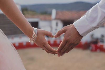 Close-up of couple holding hands