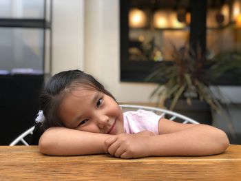 Portrait of cute girl on table