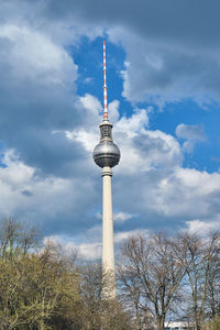 The fernsehturm, berlins highest building, with a cloudy sky