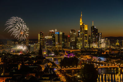 Fireworks mainfest frankfurt in front of illuminated city skyline