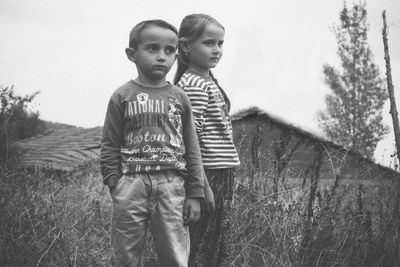 Portrait of boy standing on field