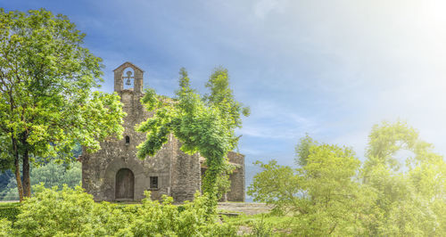 Old catholic church with a bell in soft sunlight. selective focus