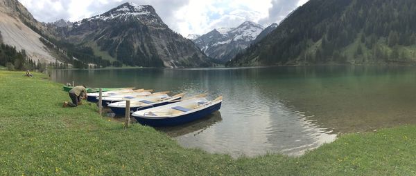 Scenic view of lake and mountains against sky