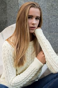 Portrait of young woman sitting outdoors