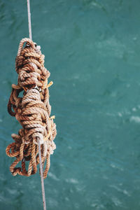 Close-up of rope tied to boat in sea