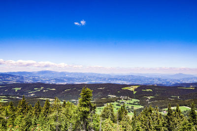 Scenic view of landscape against blue sky