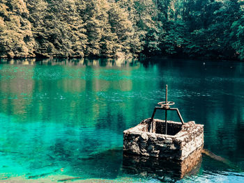 Boat in lake against trees