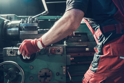 Midsection of man working in workshop