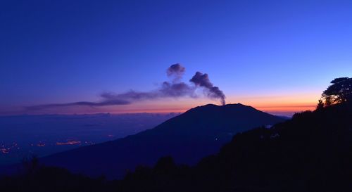 Scenic view of silhouette mountains against sky at sunset