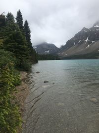 Scenic view of river and mountains against sky